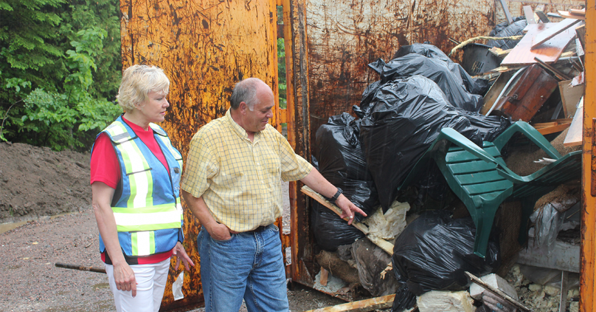 How You Can Help Get Fairness for Flood Victims Craig Taylor shows Cheryl Gallant his homes contents and drywall after flood clean up 1200